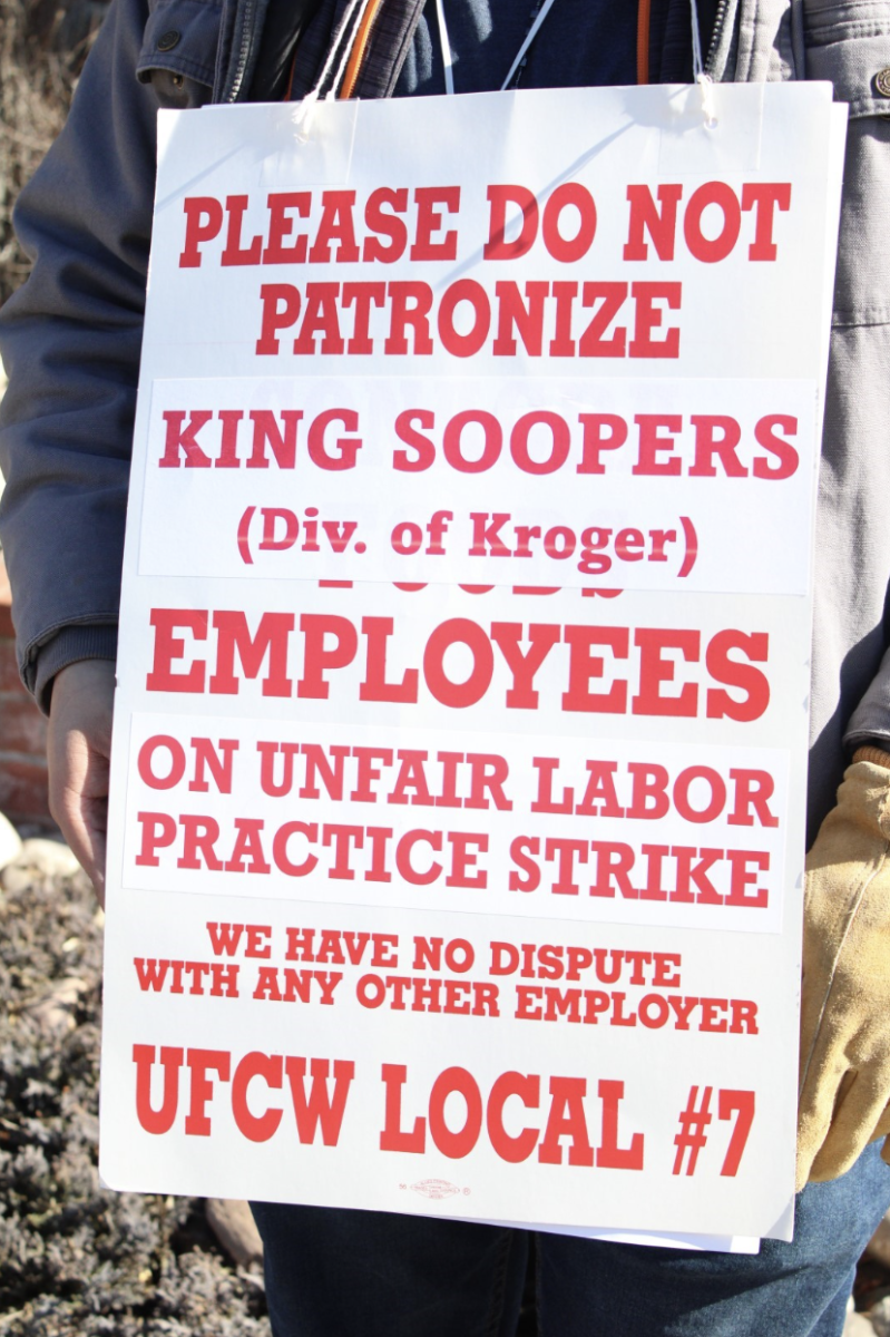 A picketer holds a sign outside a Lincoln Park King Soopers location on Feb. 6, 2025.